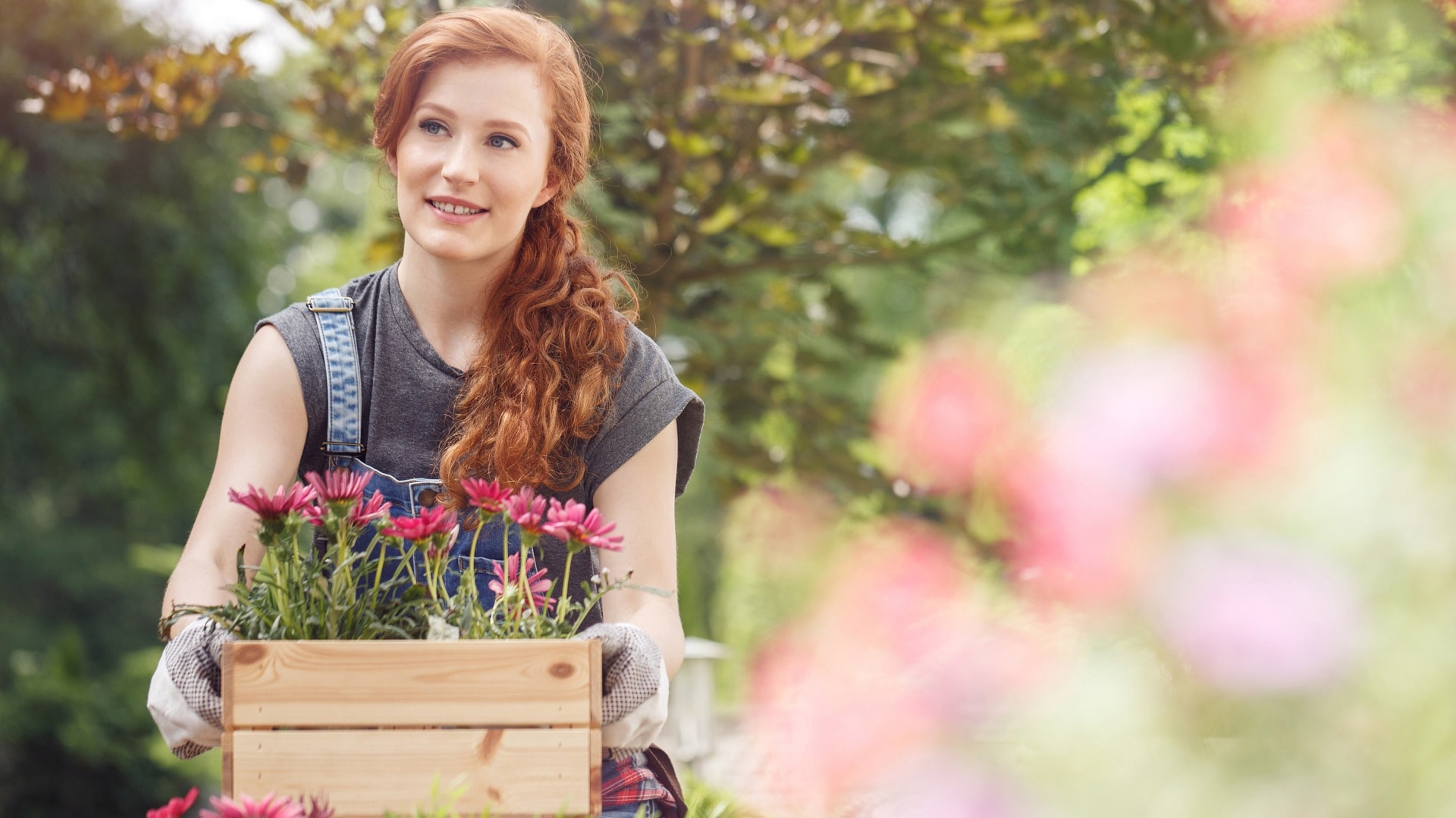 nuori-nainen-ja-kukkalaaatikko-iSt-919084704