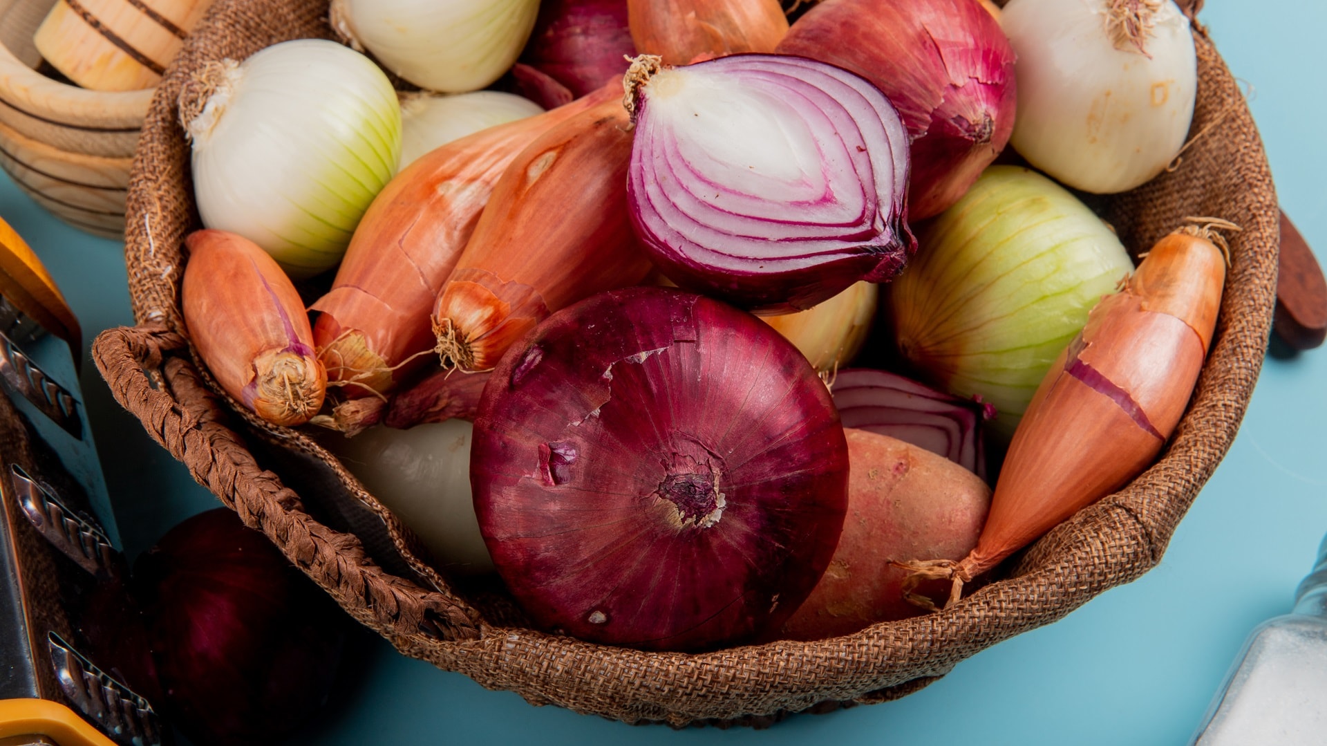 side-view-of-different-onions-in-basket-with-salt-2024-10-18-05-41-28-utc